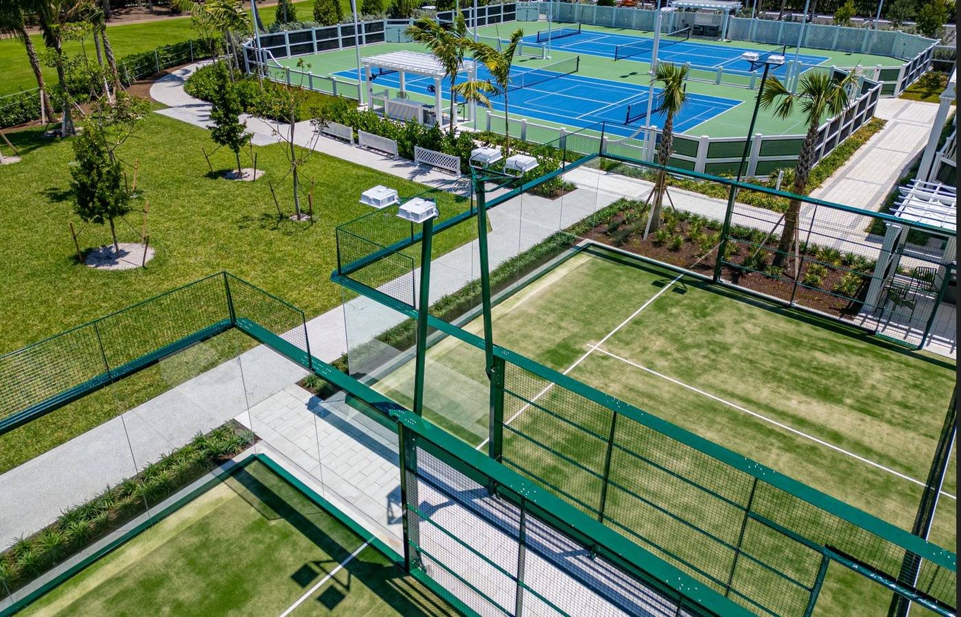 Glass wall corner and steel posts of a padel court at The Breakers, Palm Beach
